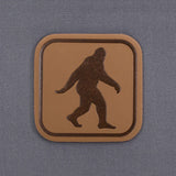 Bigfoot Trail Sign (Leather) - Flexfit® Mesh Trucker Cap Color: Coyote/Black - Eternal Glyph LLC