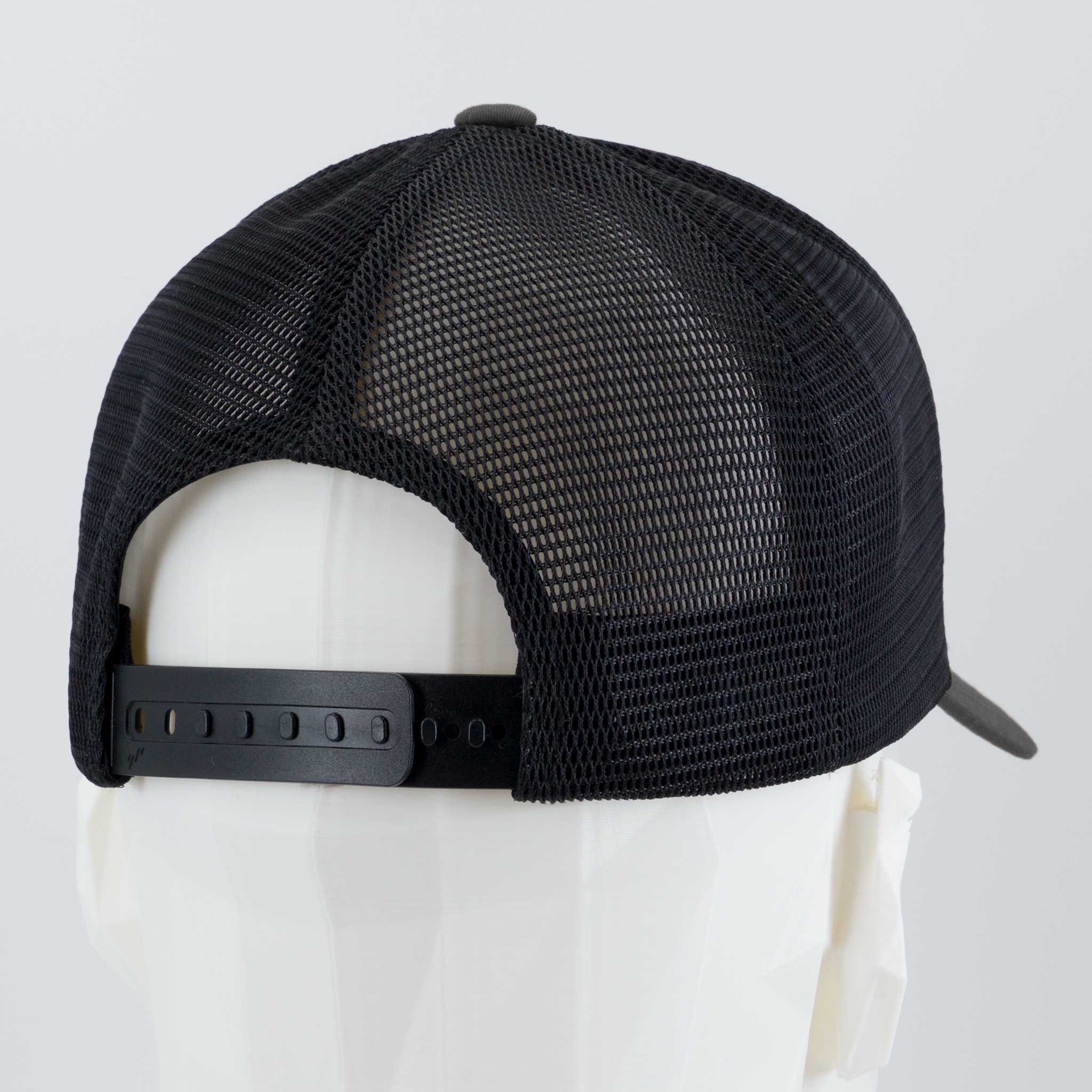 The Eternal Glyph Mountain Bike Downhill (Silicone) Flexfit® Mesh Trucker Cap, a black adjustable hat ideal for mountain biking fans, is displayed on a white mannequin head turned away from the camera.