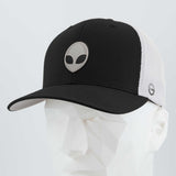 The Eternal Glyph Alien Gray (Double Layer Silicone) Flexfit® Mesh Trucker Cap features a black and white design with a grey alien logo, inspired by UFO pop culture, modeled on a white geometric mannequin head.