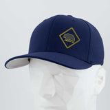 The Eternal Glyph Bear Crossing Sign (Silicone) Flexfit® Premium Wool Blend Cap in navy blue features a yellow-outlined diamond bear logo, shown on a white mannequin head with a light gray background.