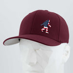 The Eternal Glyph Patriotic Bigfoot (Silicone) Flexfit® Premium Wool Blend Cap features a maroon design with a small American flag Bigfoot silhouette, shown on a white geometric mannequin head.