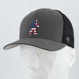 The Eternal Glyph Patriotic Bigfoot (Silicone) Flexfit® Mesh Trucker Cap in dark gray/black features a bold American flag Bigfoot design on the front, displayed on a white mannequin—ideal for fans of legendary wilderness adventures.