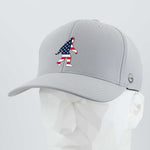 The Eternal Glyph Patriotic Bigfoot (Silicone) Flexfit® Cool & Dry Cap in light gray features a stylized American flag Bigfoot on the front and is shown on a white geometric mannequin head.