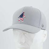 The Eternal Glyph Patriotic Bigfoot (Silicone) Flexfit® Cool & Dry Cap in light gray features a stylized American flag Bigfoot on the front and is shown on a white geometric mannequin head.