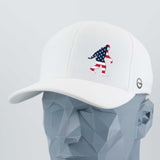 The Eternal Glyph Patriotic Bigfoot (Silicone) Flexfit® Cool & Dry Cap features a white design with an American flag Bigfoot on the front and a side logo—ideal for wilderness folklore fans. Displayed on a faceted gray mannequin head.