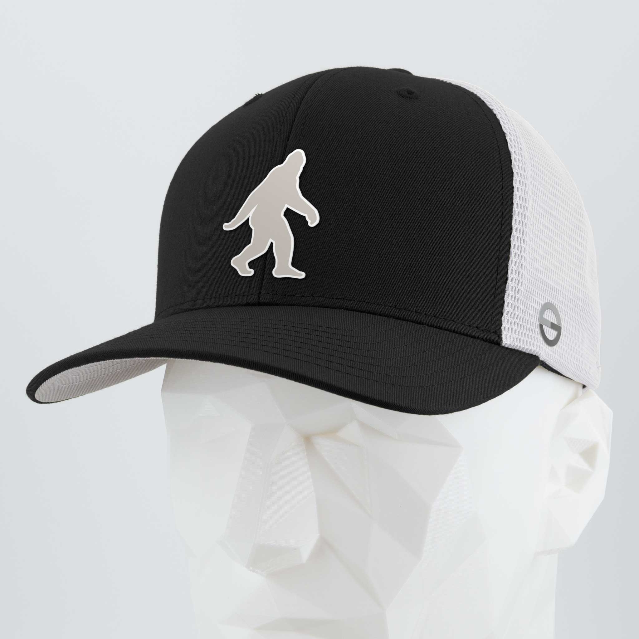 The Eternal Glyph Bigfoot Silhouette Albino (Silicone) Flexfit® Mesh Trucker Cap in Black/White features a bold Bigfoot silhouette on the front and is displayed on a faceted white mannequin head.