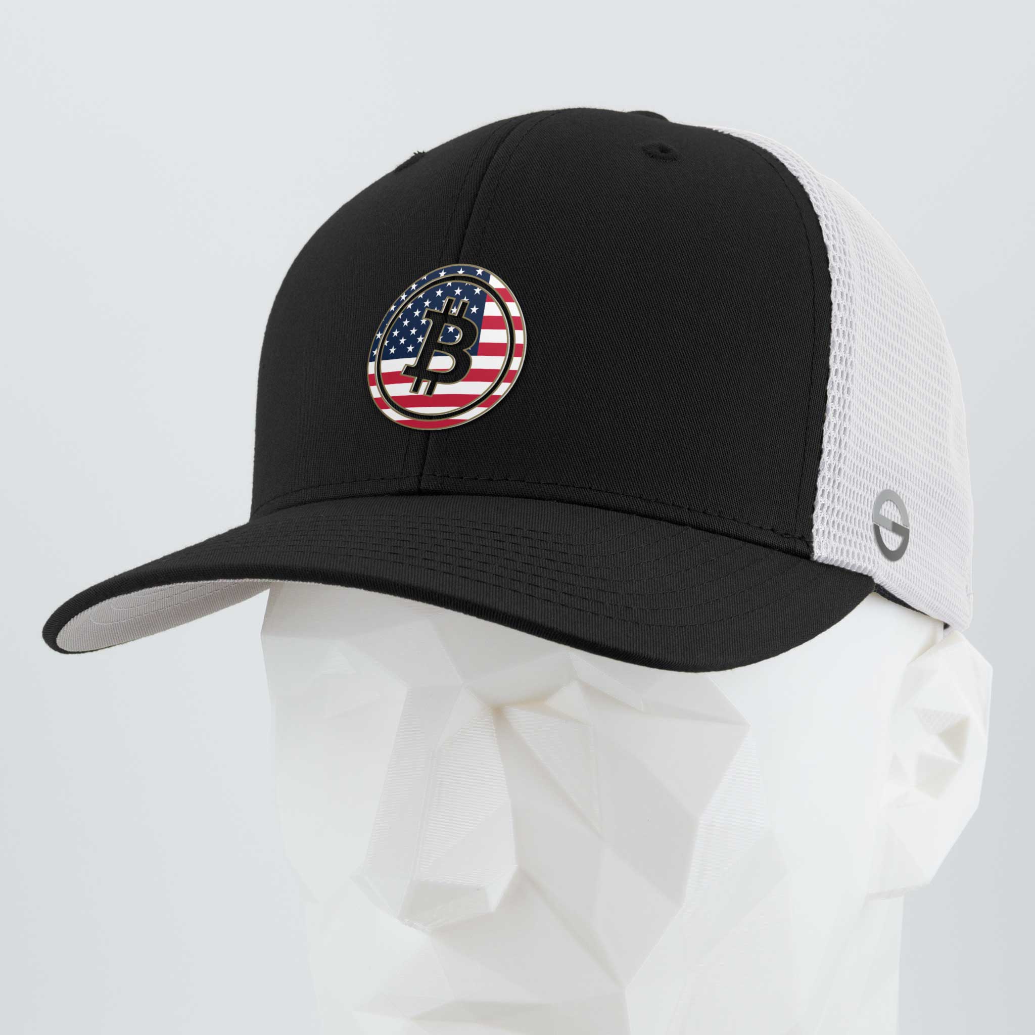 Showcasing the Bitcoin U.S.A. (Silicone) Flexfit® Mesh Trucker Cap by Eternal Glyph in black/white, this cap features a circular Bitcoin glyph with an American flag design—ideal for digital currency enthusiasts. Displayed on a white geometric mannequin head.