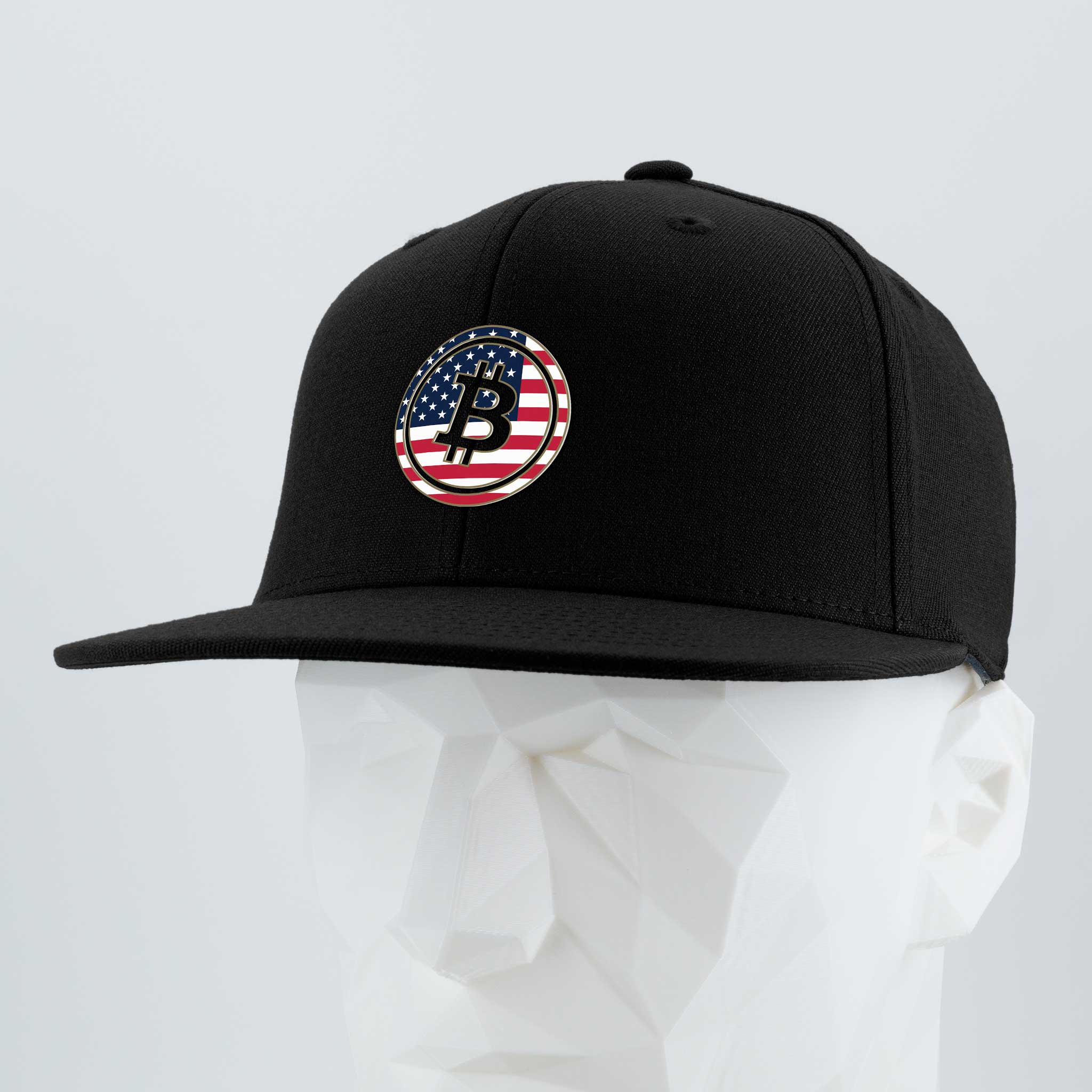 The Eternal Glyph Bitcoin U.S.A. (Silicone) Flexfit® Flat Bill Premium Fitted Cap, in black, features a circular patch with a Bitcoin USA glyph over an American flag on the front, shown on a white faceted mannequin head.