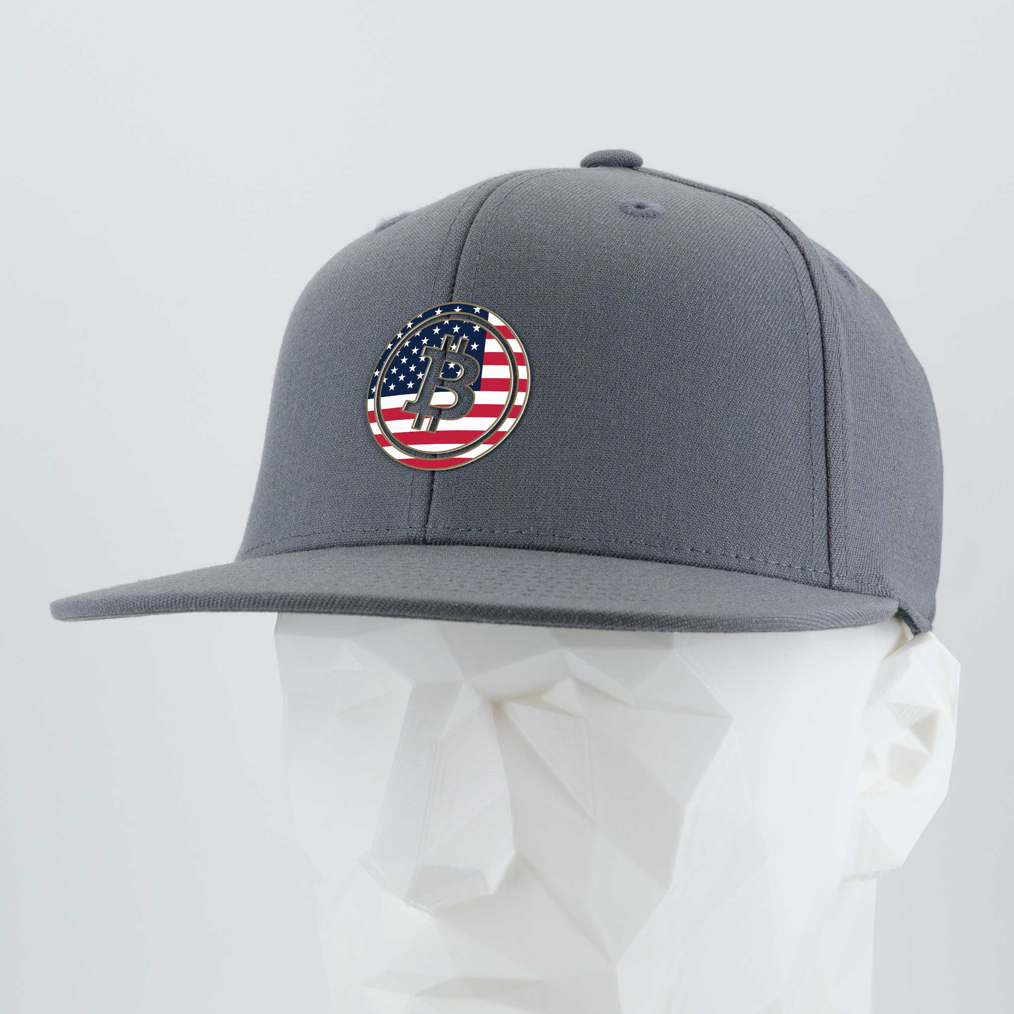 The Eternal Glyph Bitcoin U.S.A. Flexfit® Flat Bill Premium Fitted Cap features a gray design, a round American flag patch with a stylized P, and is perfect for those who value financial freedom and digital money style.