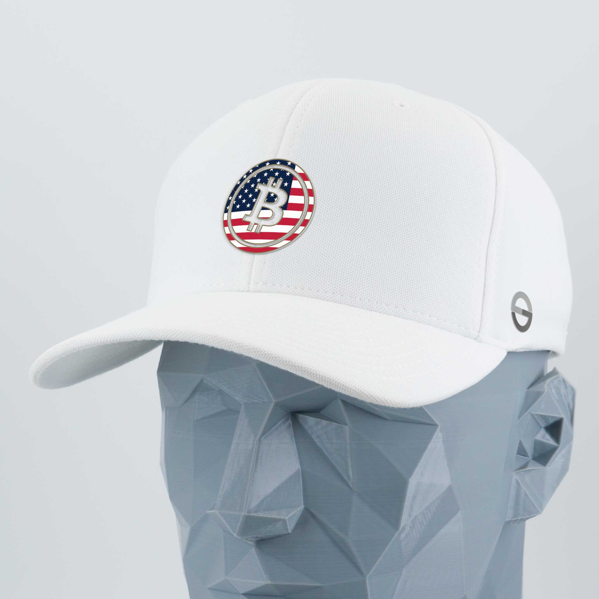 The Eternal Glyph Bitcoin U.S.A. (Silicone) - Flexfit® Cool & Dry Cap in white, featuring a circular stylized B over an American flag, is shown on a geometric gray mannequin head.