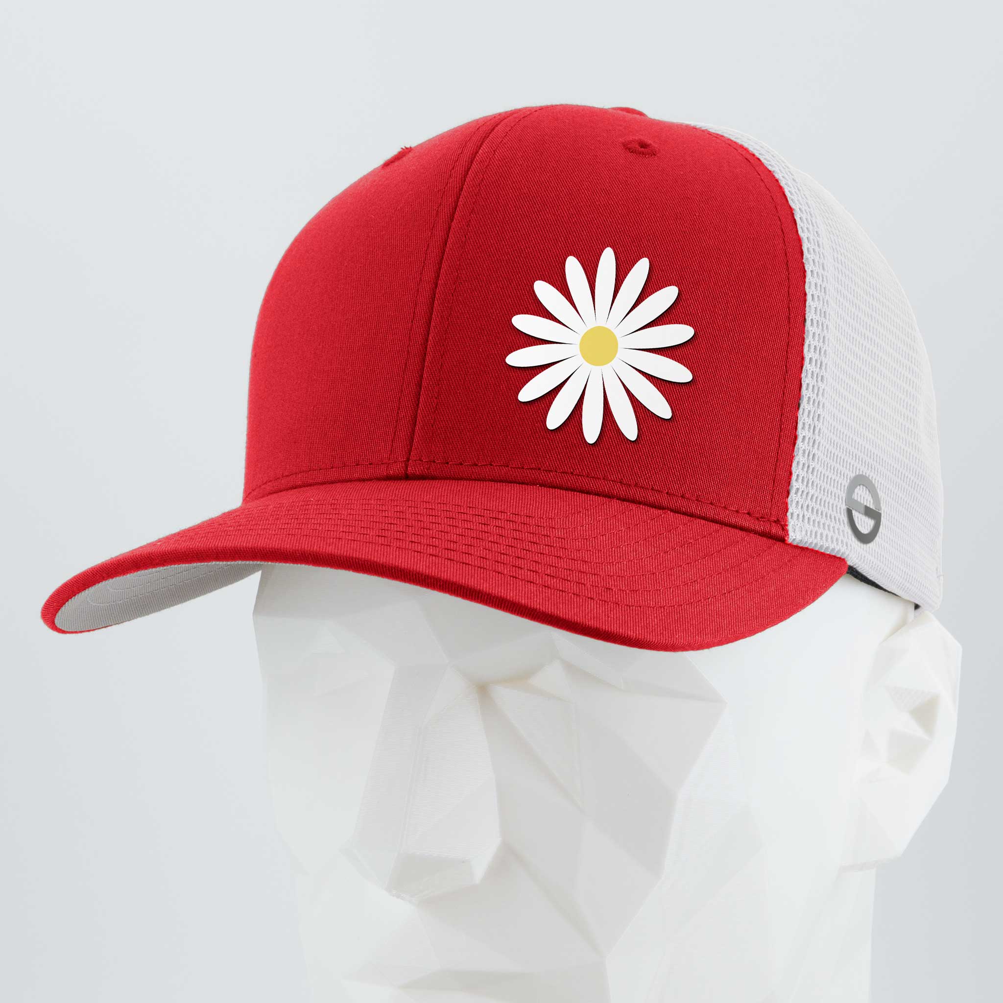 The Daisy (Silicone) - Flexfit® Mesh Trucker Cap by Eternal Glyph features a red and white design with a stylized daisy optimism symbol, white mesh back, and is displayed on a white geometric mannequin head.