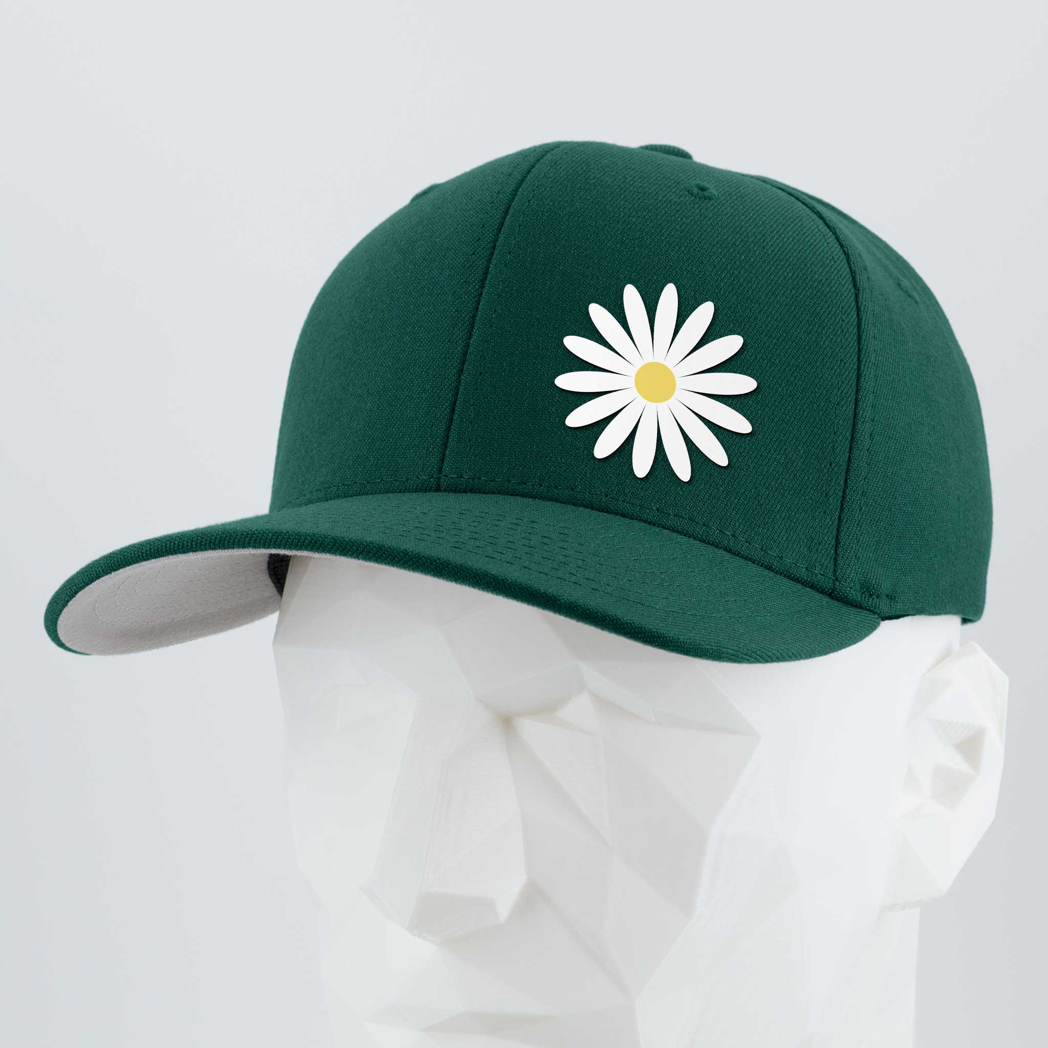 The Daisy (Silicone) - Flexfit® Premium Wool Blend Cap by Eternal Glyph features a dark green design with a white and yellow daisy embroidered on the front, shown on a mannequin against a light gray background. A cheerful everyday accessory.