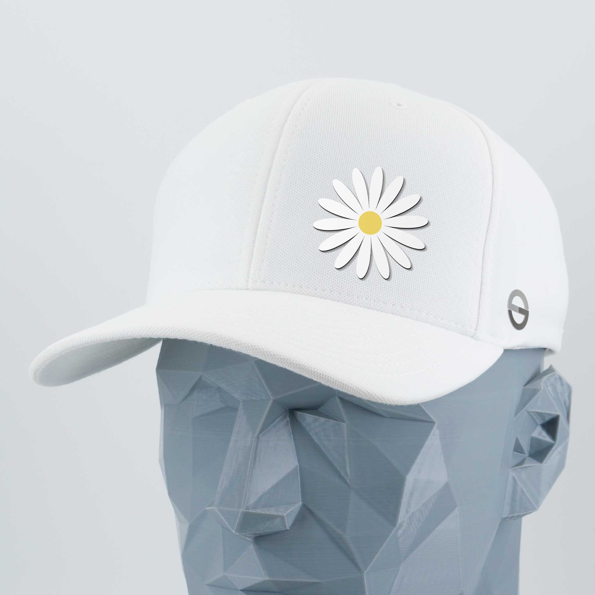 The Daisy - Flexfit® Cool & Dry Cap by Eternal Glyph is an everyday white cap with a daisy glyph on the front, shown on a gray geometric mannequin head against a light background.