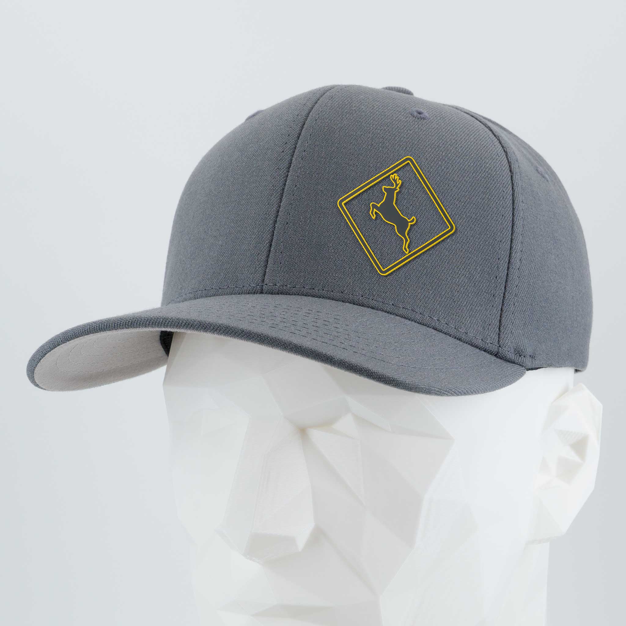 The Flexfit® Premium Wool Blend Cap by Eternal Glyph features a subtle deer crossing sign in silicone, highlighting a connection to nature.