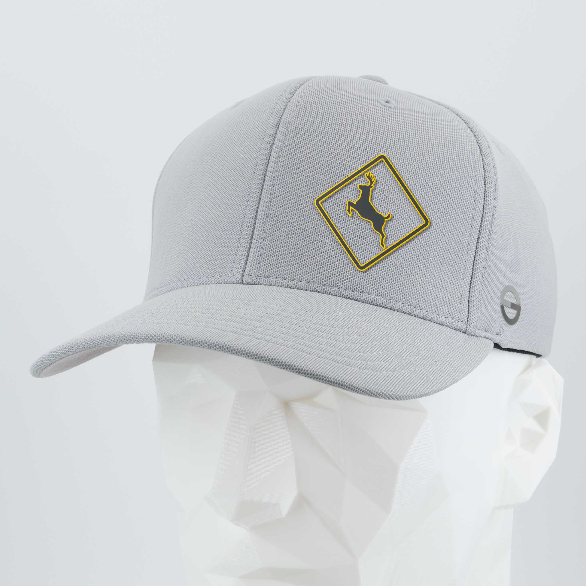 The Eternal Glyph Deer Crossing Sign (Silicone) - Flexfit® Cool & Dry Cap features a light gray design with a yellow-outlined deer logo in a diamond shape on the front, shown on a white geometric mannequin head.