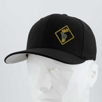 The Eternal Glyph Elk Crossing Sign (Silicone) - Flexfit® Premium Wool Blend Cap features a black design with a yellow elk crossing sign, shown on a white geometric mannequin head against a simple light background.