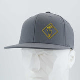 Eternal Glyph’s Elk Crossing Sign (Silicone) Flexfit® Flat Bill Premium Fitted Cap in gray features a yellow-outlined deer patch and text, shown on a white geometric mannequin head against a plain background.