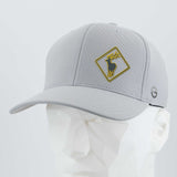 The Eternal Glyph Elk Crossing Sign (Silicone) - Flexfit® Cool & Dry Cap, shown on a faceted white mannequin head, features a yellow and black elk sign patch on the front and a small circular side logo.