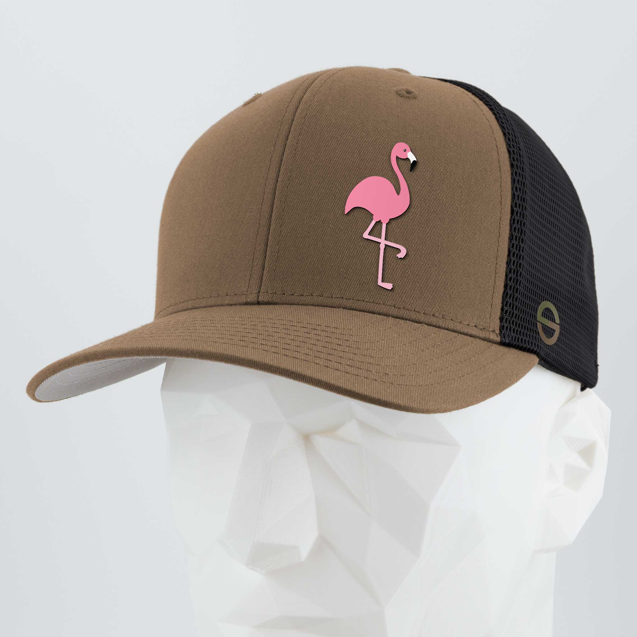 The Eternal Glyph Pink Flamingo (Silicone) Flexfit® Mesh Trucker Cap in Coyote/Black features a flamingo glyph on the front, evoking retro lawn flamingos and summer vibes. Shown on a white geometric mannequin head.