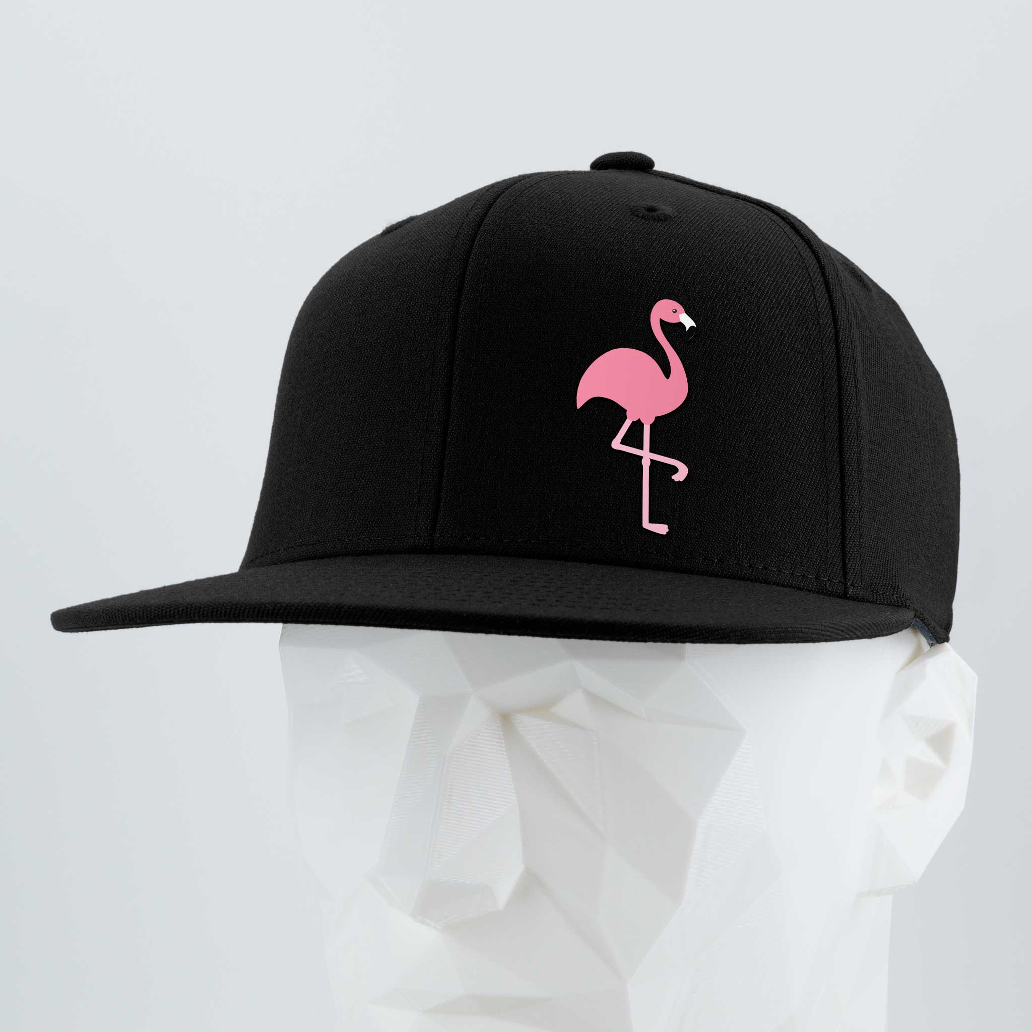 The Eternal Glyph Pink Flamingo (Silicone) Flexfit® Flat Bill Premium Fitted Cap features a black snapback design with a pink flamingo glyph on the front, capturing retro vacation vibes and summer energy. Displayed on a white geometric mannequin head.