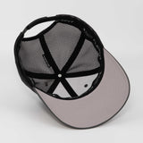 The Eternal Glyph Hiker Trail Sign (Silicone) Flexfit® Mesh Trucker Cap is shown upside down, revealing its gray and black mesh, adjustable snapback, stitched panels, and a light gray brim—ideal for outdoor adventures.
