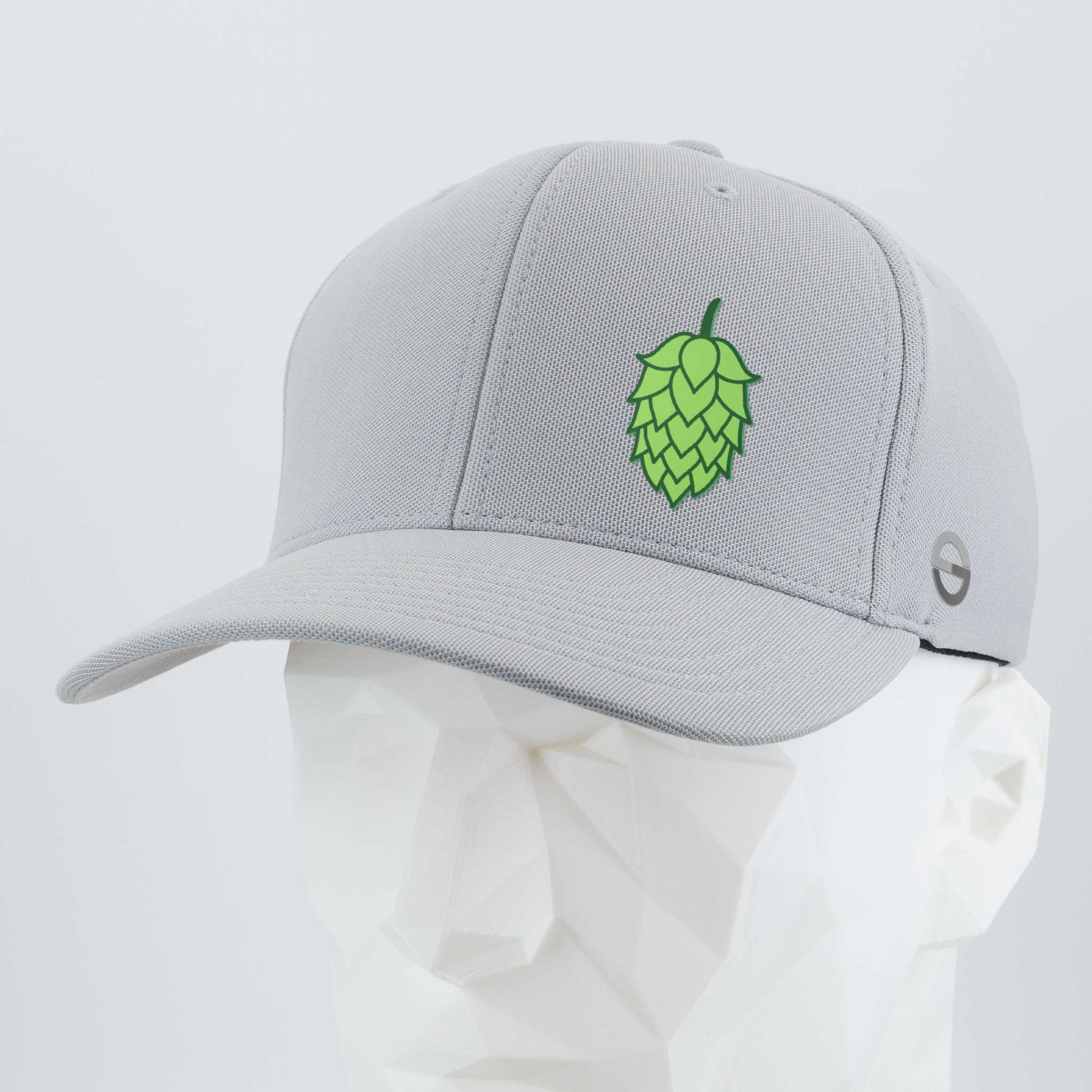 The Eternal Glyph Hop Cone (Silicone) Flexfit® Cool & Dry Cap is a light gray baseball cap with a green hop cone symbol on the front and a small circular logo on the side, perfect for craft beer culture enthusiasts.