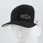The Eternal Glyph Large Mouth Bass Fishing Flexfit® Mesh Trucker Cap in Black/White features a silicone bass silhouette patch, shown on a white geometric mannequin head against a plain background.