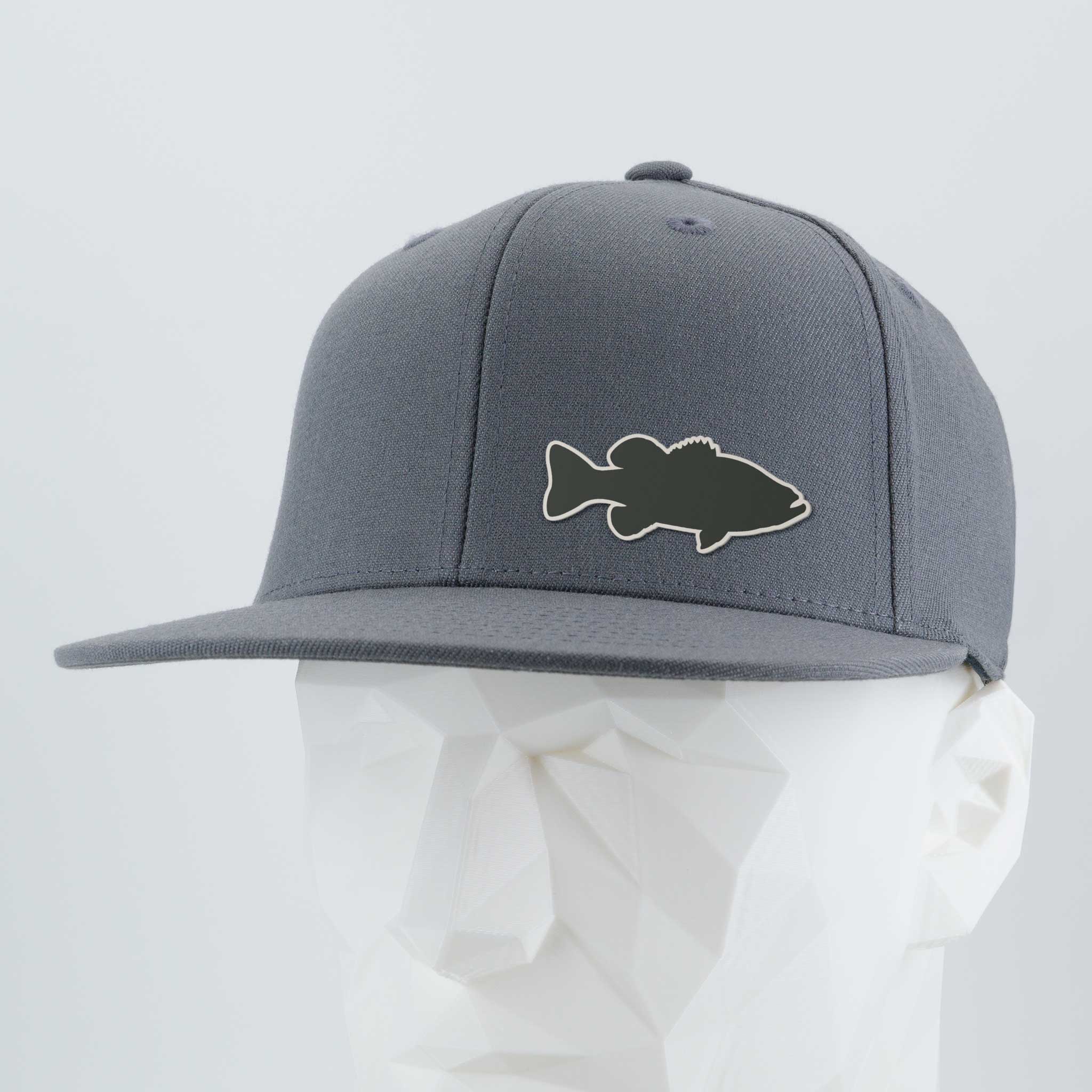The Eternal Glyph Large Mouth Bass (Silicone) Flexfit® Flat Bill Premium Fitted Cap in gray features a black bass fishing silhouette patch on the front, shown on a white geometric mannequin head.