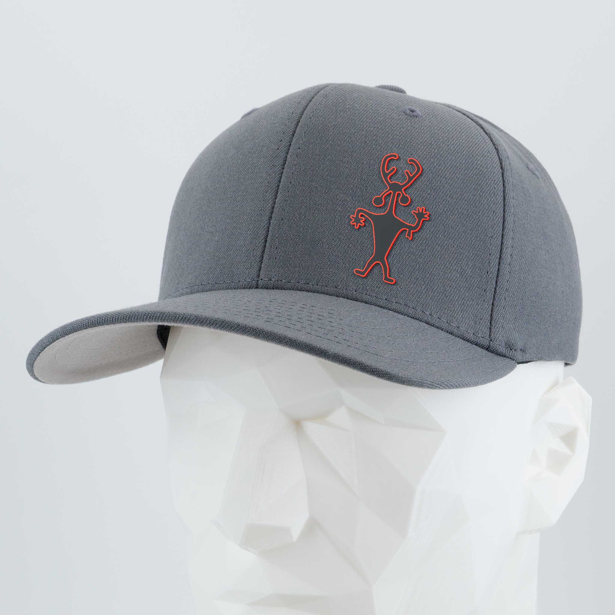 The Eternal Glyph Moab Man Petroglyph (Silicone) Flexfit® Premium Wool Blend Cap in dark gray features an abstract red stick-figure design, inspired by a Utah petroglyph, shown on a faceted white mannequin against a light background.