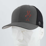 The Eternal Glyph Moab Man Petroglyph (Silicone) Flexfit® Mesh Trucker Cap in gray and black features a red outlined Moab Man logo on the front, displayed on a white faceted mannequin head against a light background.