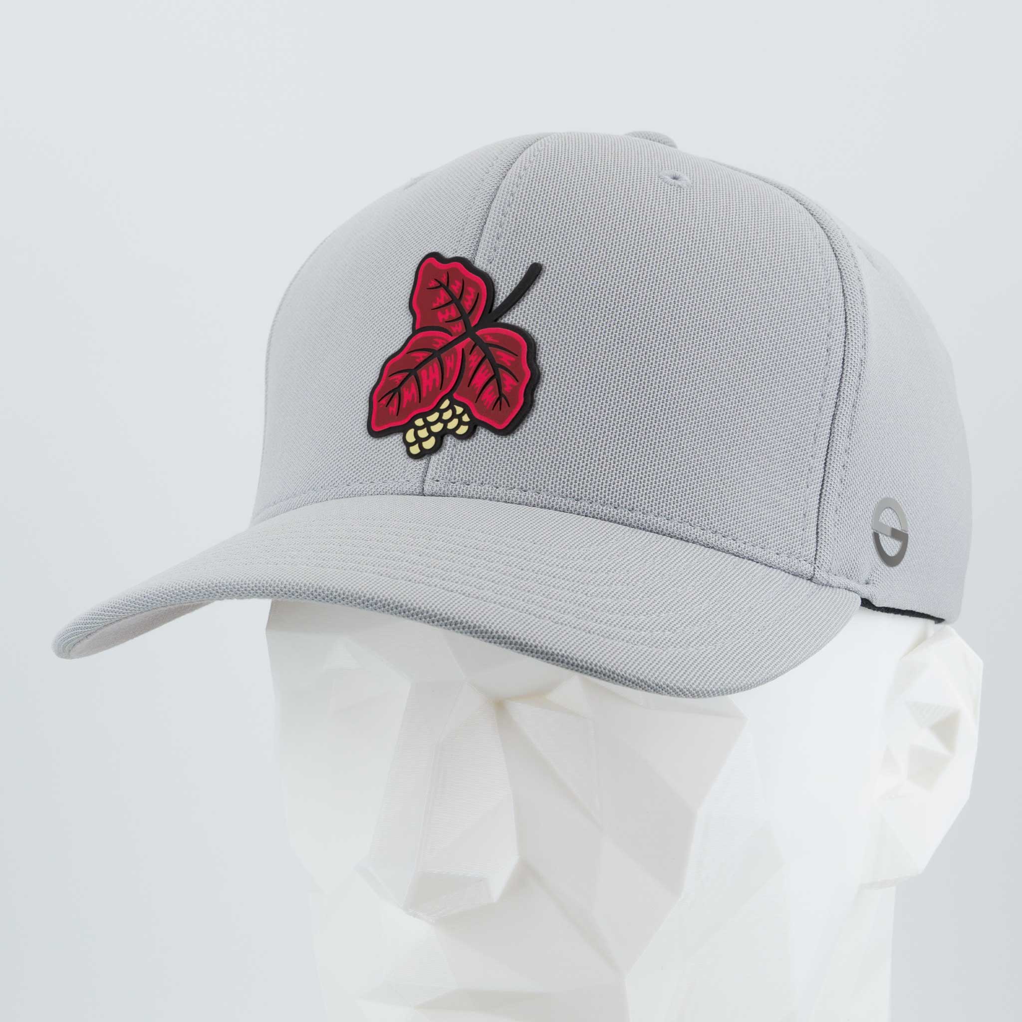 The Eternal Glyph Poison Oak (Double Layer Silicone) Flexfit® Cool & Dry Cap features a light gray design with a red leaf and yellow berries embroidered on the front, shown here atop a white geometric mannequin head.