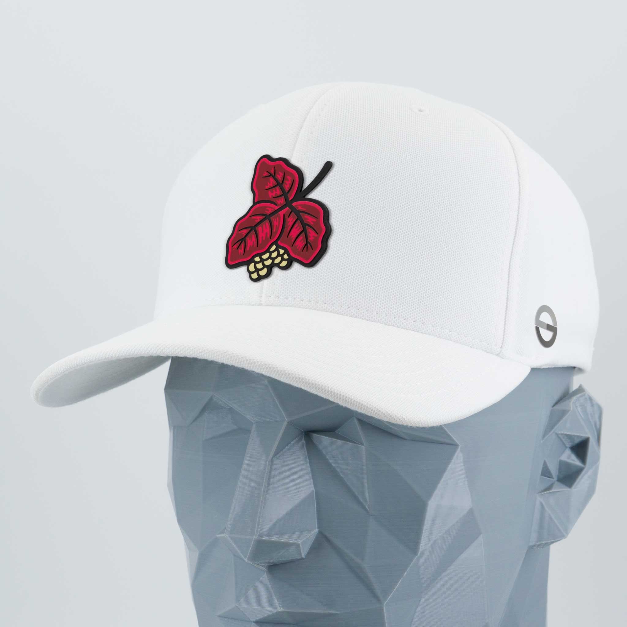 The Eternal Glyph Poison Oak (Double Layer Silicone) Flexfit® Cool & Dry Cap is a white cap with a red and yellow poison oak leaf patch on the front and a small circular logo on the side, shown on a geometric gray mannequin head.