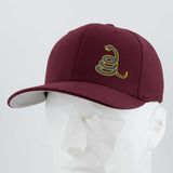 The Eternal Glyph Coiled Rattlesnake Silhouette Flexfit® Premium Wool Blend Cap in maroon features a yellow snake design, inspired by the Gadsden flag, shown on a white geometric mannequin against a plain background.