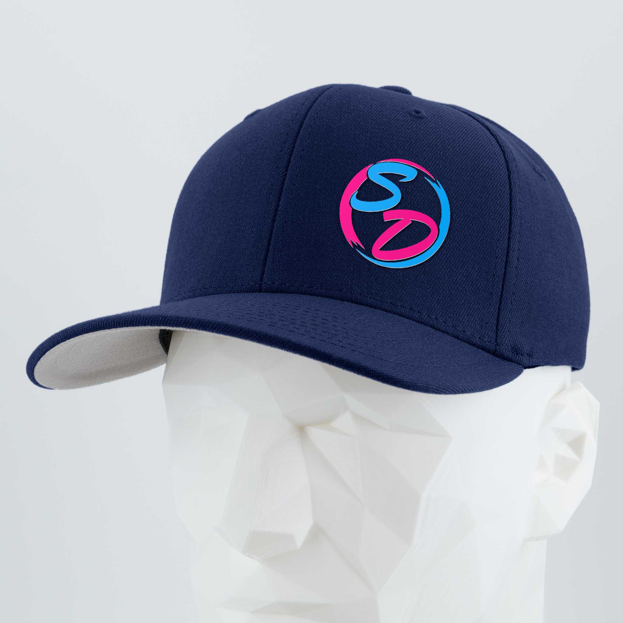 Introducing the Staying Driven (Silicone) - Flexfit® Premium Wool Blend Cap by Eternal Glyph, in sleek navy. Featuring a silicone SD logo in vibrant pink and blue on the front, this premium headwear—displayed on a white geometric mannequin head—is the perfect accessory for any online fitness community.