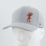 The Eternal Glyph Moab Shaman Petroglyph (Silicone) Flexfit® Cool & Dry Cap in silver, featuring a red and black Kokopelli design inspired by the Moab petroglyph, is shown on a white angular mannequin against a light gray background.