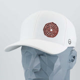 The Eternal Glyph Moab Spiral Petroglyph (Silicone) Flexfit® Cool & Dry Cap in white features an orange spiral petroglyph on the front and a small circular ancient symbol on the side, shown on a gray geometric mannequin head.