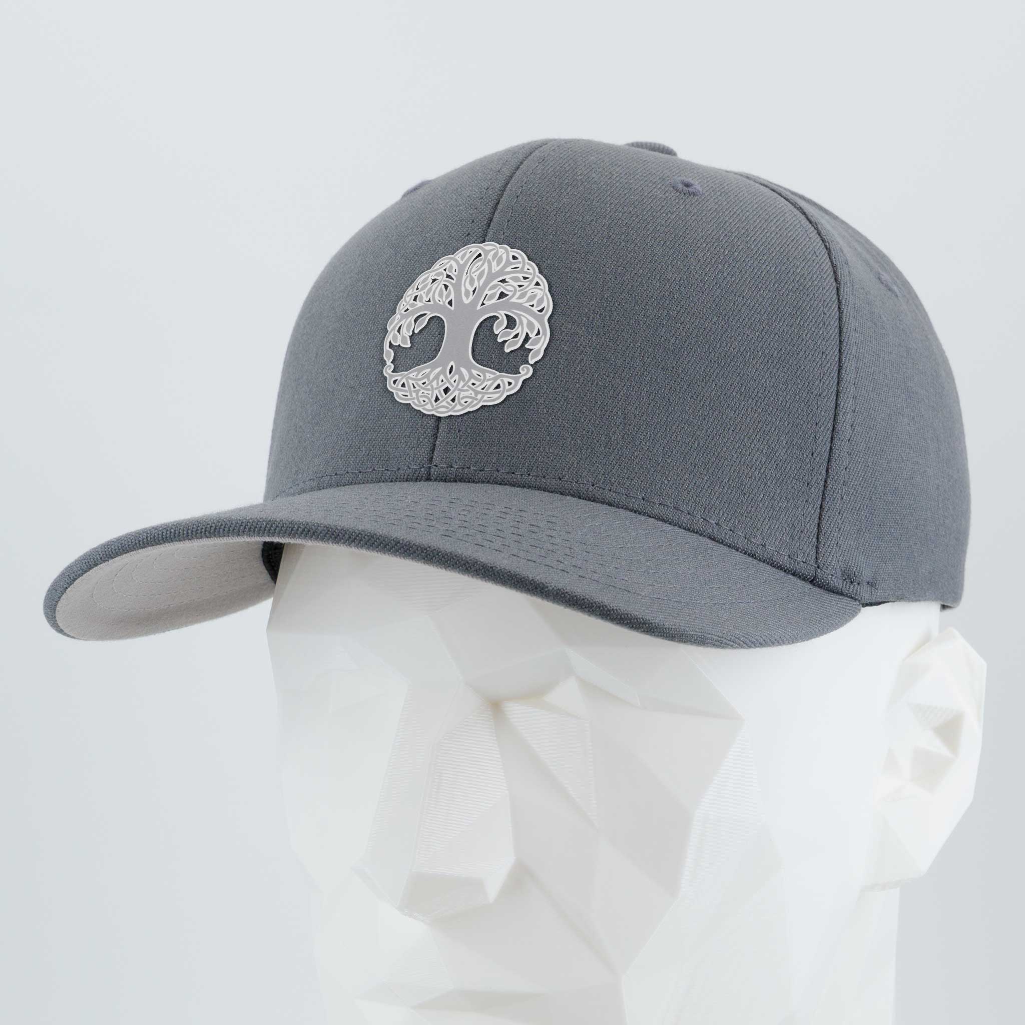 The Eternal Glyph Tree of Life, Yggdrasil, Metallic Silver Flexfit® Cap displays a striking Norse symbol in metallic silver on gray wool blend, shown atop a white faceted mannequin head set against a plain light background.