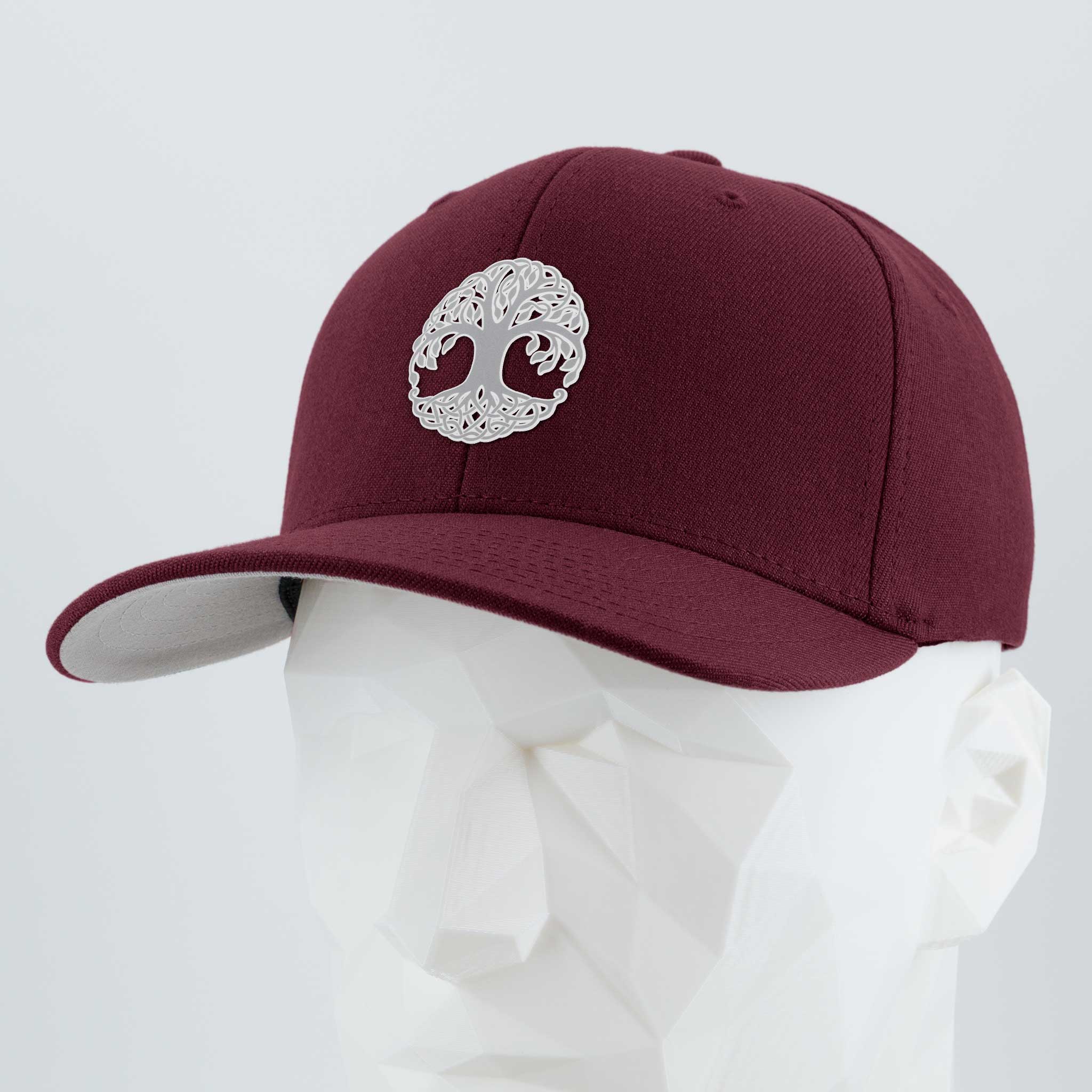 The Eternal Glyph Tree of Life, Yggdrasil, Metallic Silver Flexfit® Premium Wool Blend Cap features a silver embroidered Yggdrasil emblem and is displayed on a white geometric mannequin head against a light gray background.