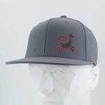 The Eternal Glyph Moab Trickster, Coyote Petroglyph (Silicone) Flexfit® Flat Bill Premium Fitted Cap, in gray with a red kangaroo-like logo, is shown on a white mannequin head against a light gray background.
