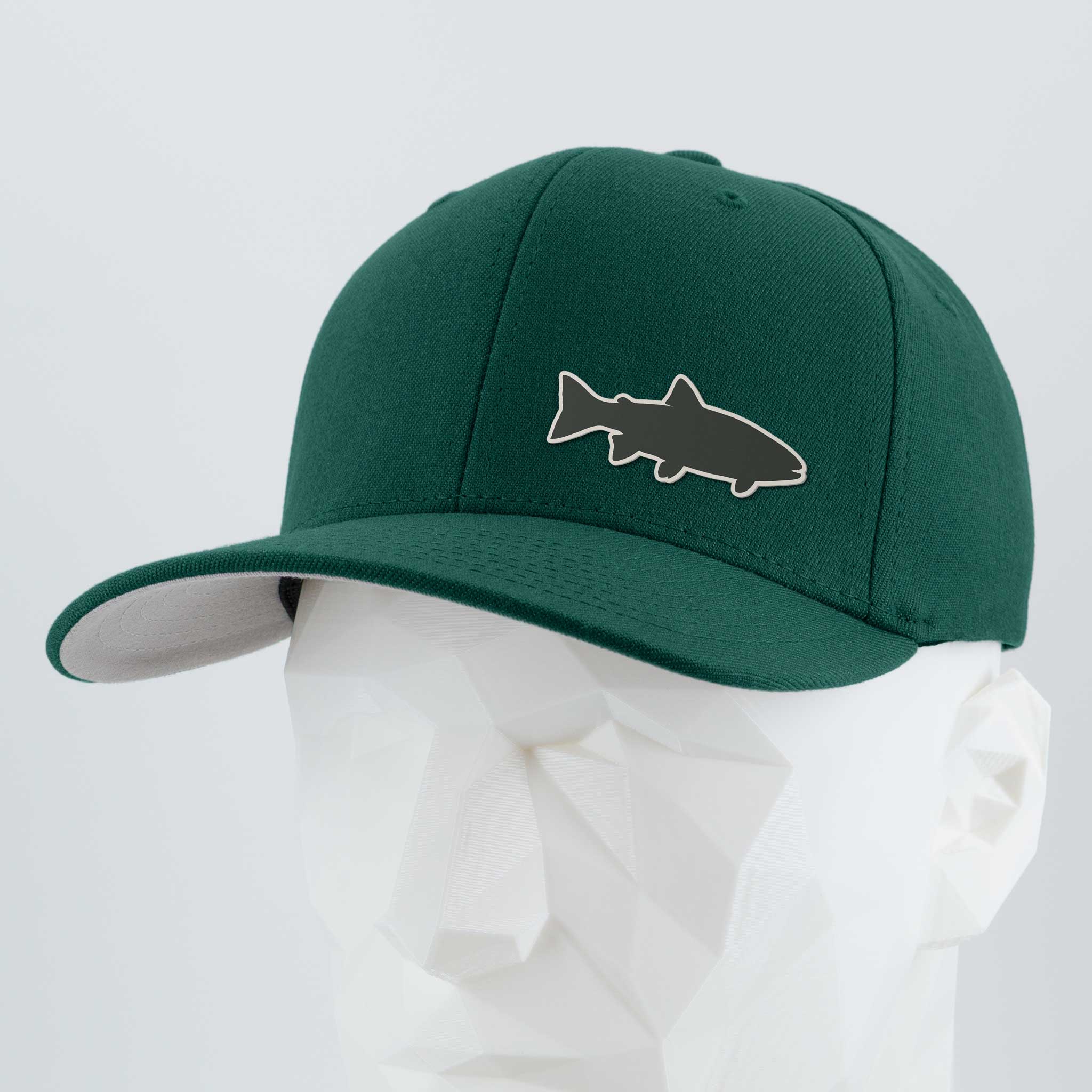 The Eternal Glyph Trout Fishing (Silicone) Flexfit® Premium Wool Blend Cap in dark green features a fish silhouette, ideal for trout fishing in alpine lakes, shown on a faceted white mannequin against a light background.