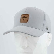 The Eternal Glyph UFO Area Trail Sign (Leather) Flexfit® Cool & Dry Cap, in light gray, is shown on a white mannequin. It features a brown leather patch with the trail sign design and a small circular logo on the side.