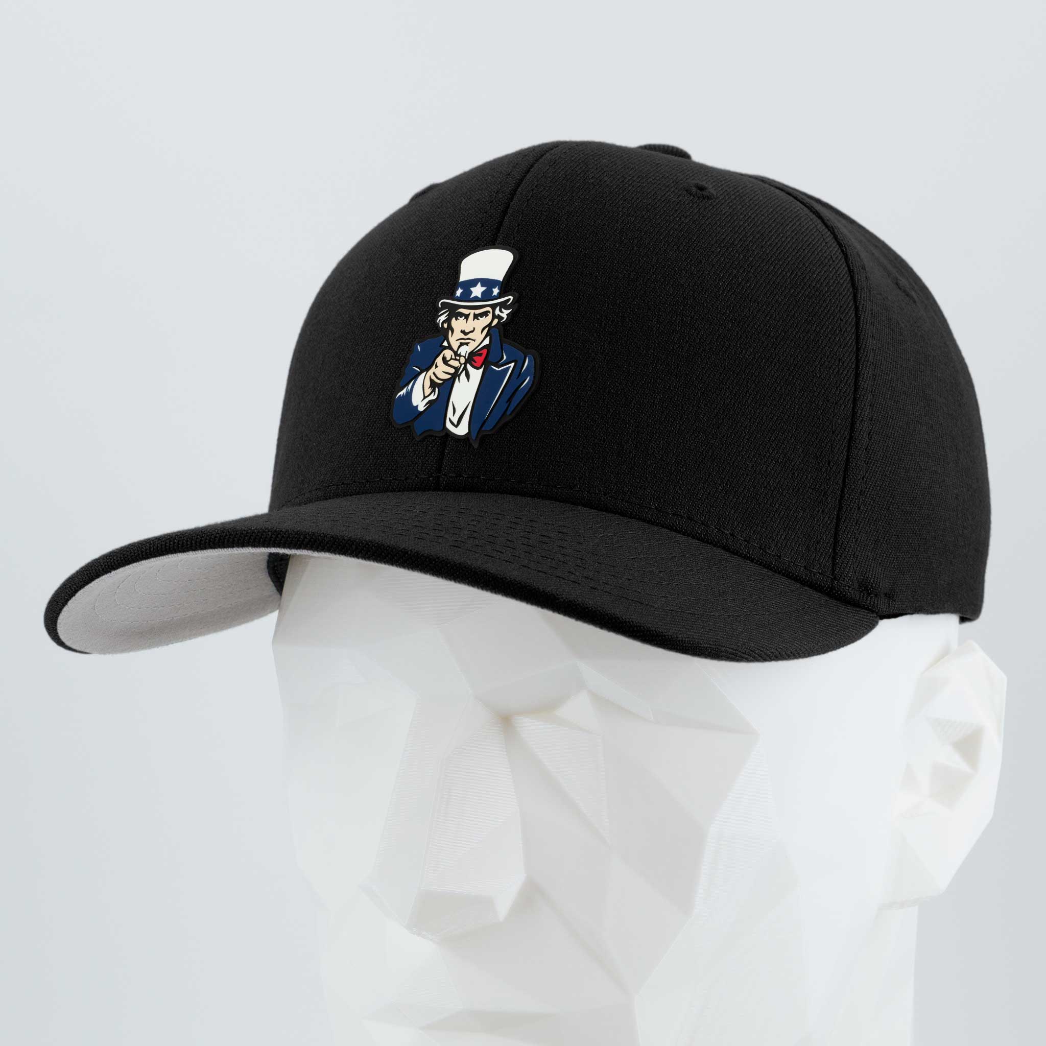 The Eternal Glyph Uncle Sam, I Want You (Silicone) Flexfit® Premium Wool Blend Cap in black features a bold embroidered patch of Uncle Sam and is showcased on a white geometric mannequin head against a light gray background.