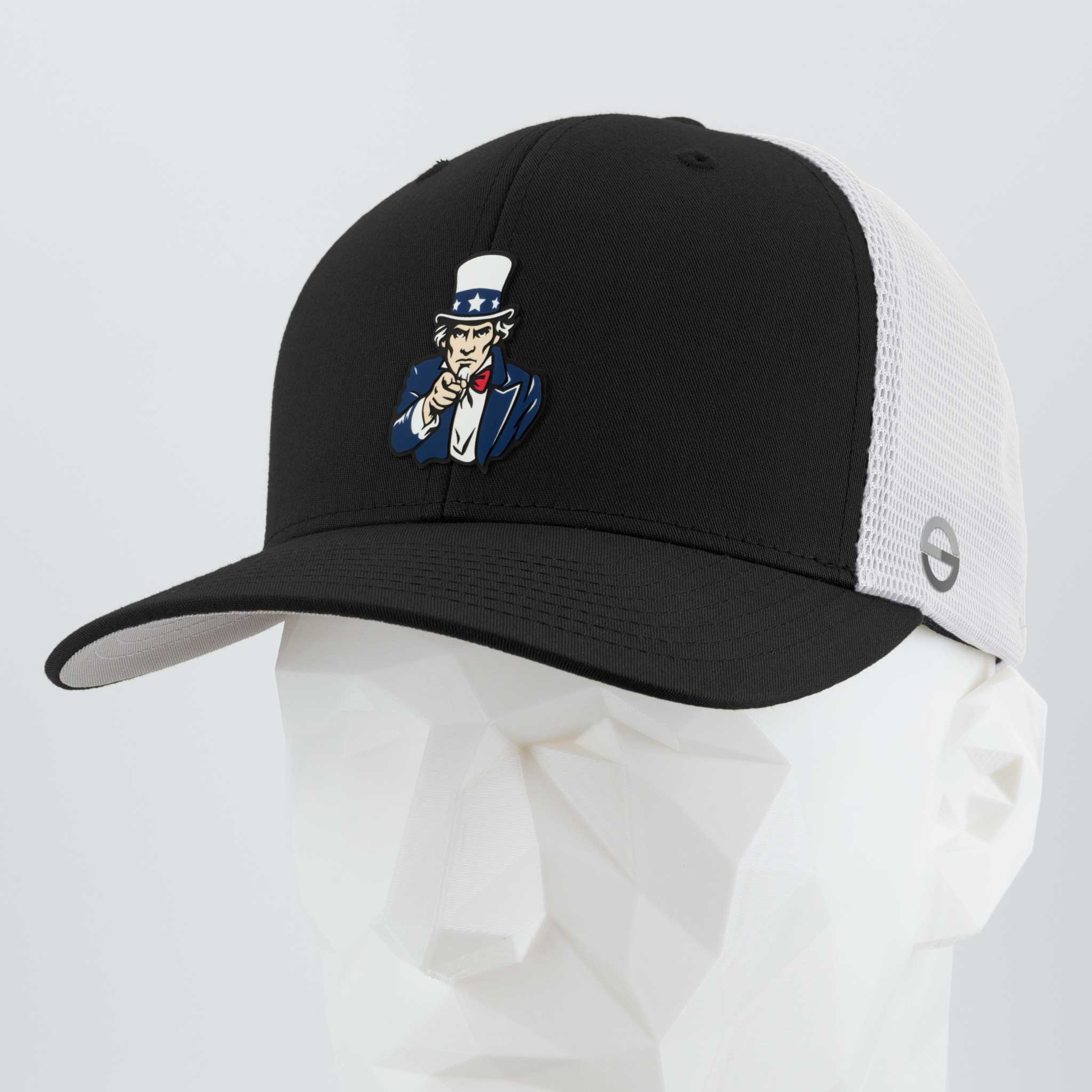 The Eternal Glyph Uncle Sam, I Want You! (Silicone) Flexfit® Mesh Trucker Cap in Black/White features an embroidered Uncle Sam patch on the front, shown on a white geometric mannequin head.