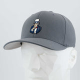 The Eternal Glyph "Uncle Sam, I Want You (Silicone)" Flexfit® Premium Wool Blend Cap in Dark Gray features a vibrant Uncle Sam patch and is shown on a white geometric mannequin head.