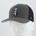 The Eternal Glyph Uncle Sam, I Want You! Flexfit® Mesh Trucker Cap in dark gray/black features Uncle Sam embroidered on the front and is shown on a white geometric mannequin head for bold patriotic flair.