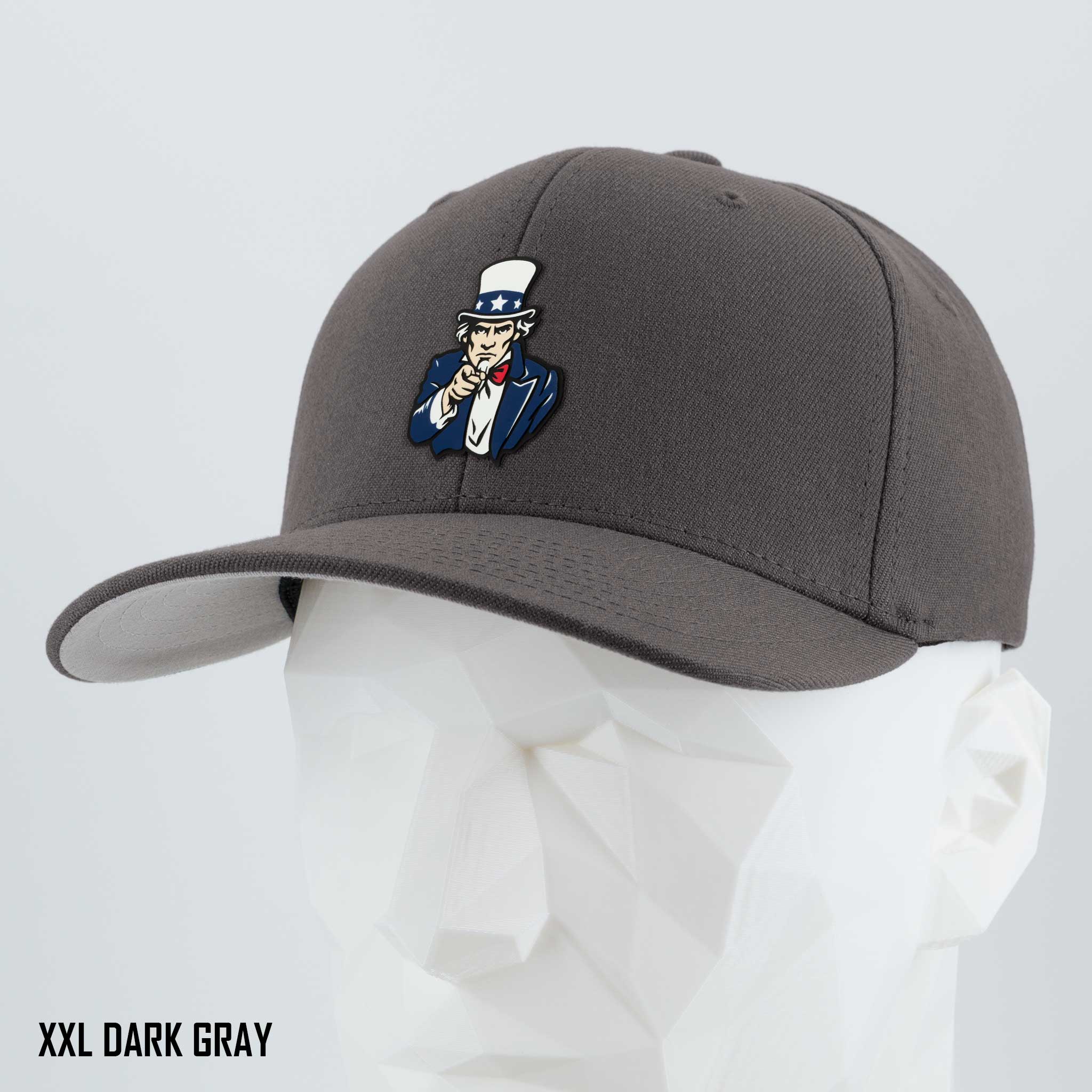 The Eternal Glyph Uncle Sam, I Want You (Silicone) Flexfit® Premium Wool Blend Cap in Dark Gray features an embroidered cartoon Uncle Sam patch. Shown on a white mannequin head. Text: XXL DARK GRAY.