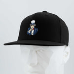 The Eternal Glyph Uncle Sam, I Want You (Silicone) Flexfit® Flat Bill Premium Fitted Cap in black features classic American imagery with an embroidered Uncle Sam pointing forward, shown on a white geometric mannequin head.