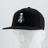 The Eternal Glyph Uncle Sam, I Want You (Silicone) Flexfit® Flat Bill Premium Fitted Cap in black features classic American imagery with an embroidered Uncle Sam pointing forward, shown on a white geometric mannequin head.