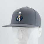 The Eternal Glyph Uncle Sam, I Want You (Silicone) Flexfit® Flat Bill Premium Fitted Cap in dark gray features an embroidered Uncle Sam cartoon, blending classic American imagery with modern patriotic style.