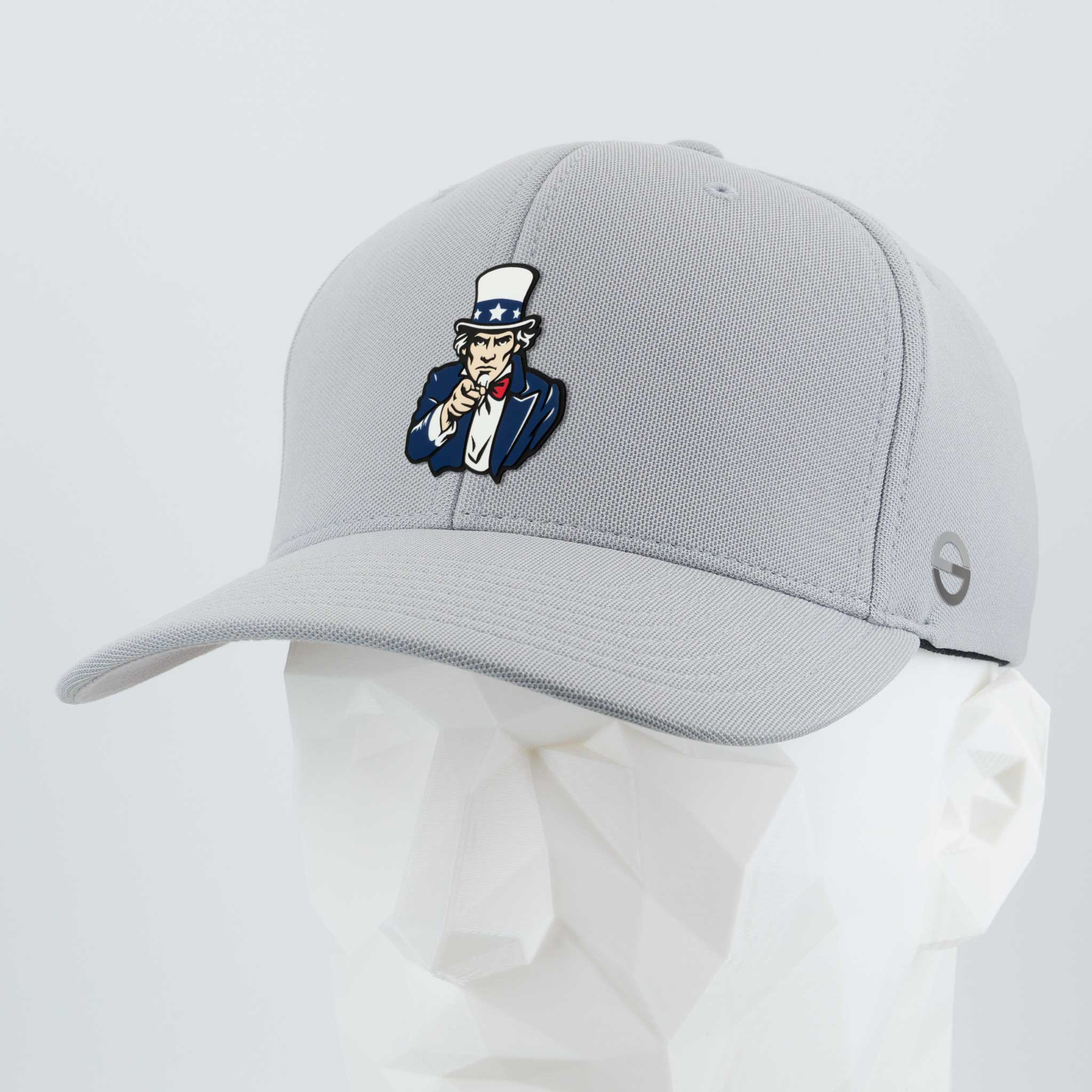 The Eternal Glyph “Uncle Sam, I Want You (Silicone)” Flexfit® Cool & Dry Cap is a light gray hat with a bold Uncle Sam patch, shown on a white mannequin head—an ideal pick for patriotic style.